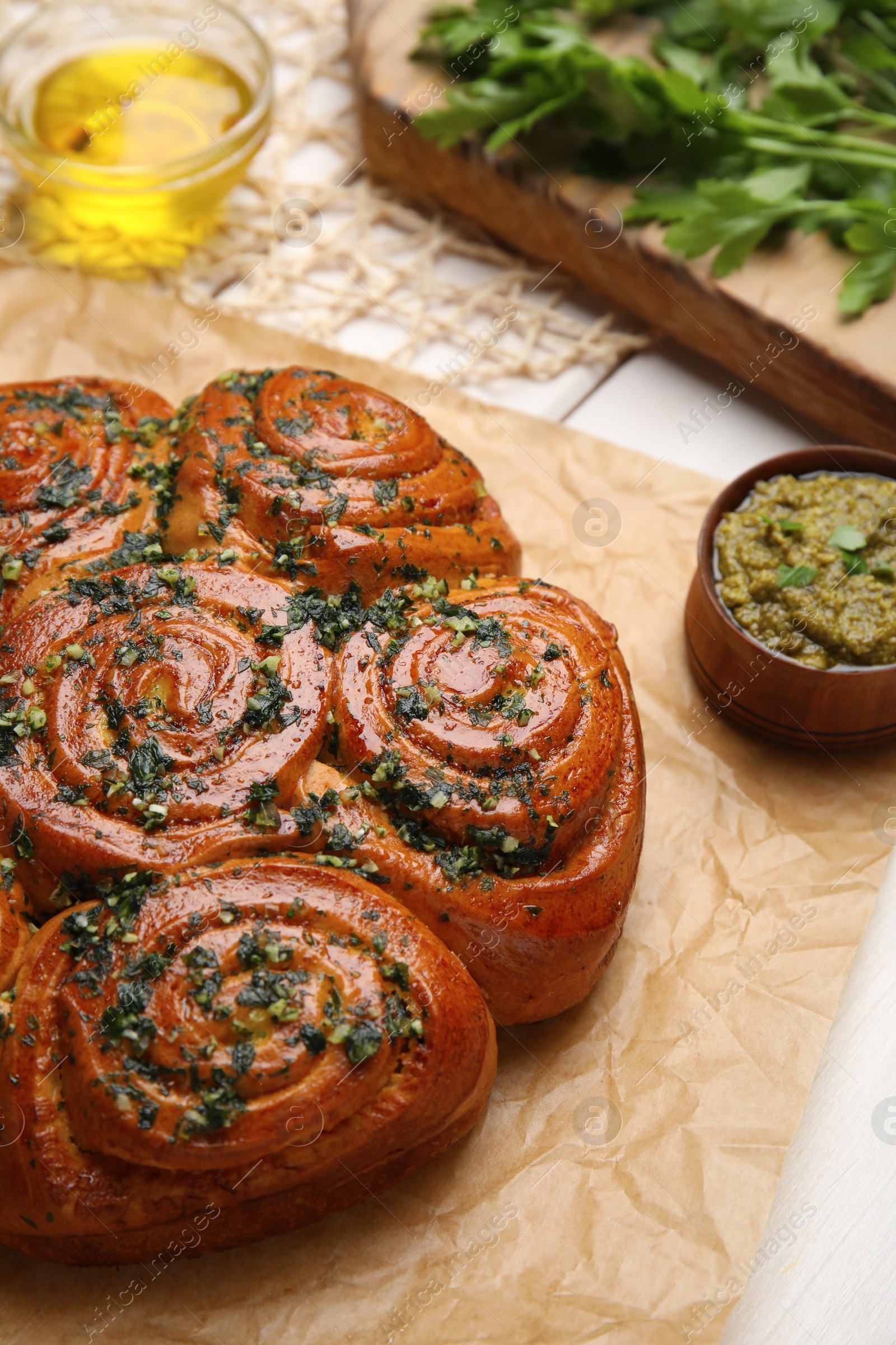 Traditional pampushka rolls with garlic and herbs on table, closeup Photo of Traditional pampushka rolls with garlic and herbs on table, closeup