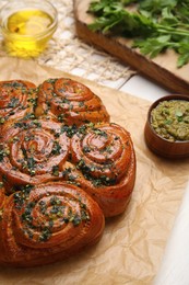 Traditional pampushka rolls with garlic and herbs on table, closeup Photo of Traditional pampushka rolls with garlic and herbs on table, closeup