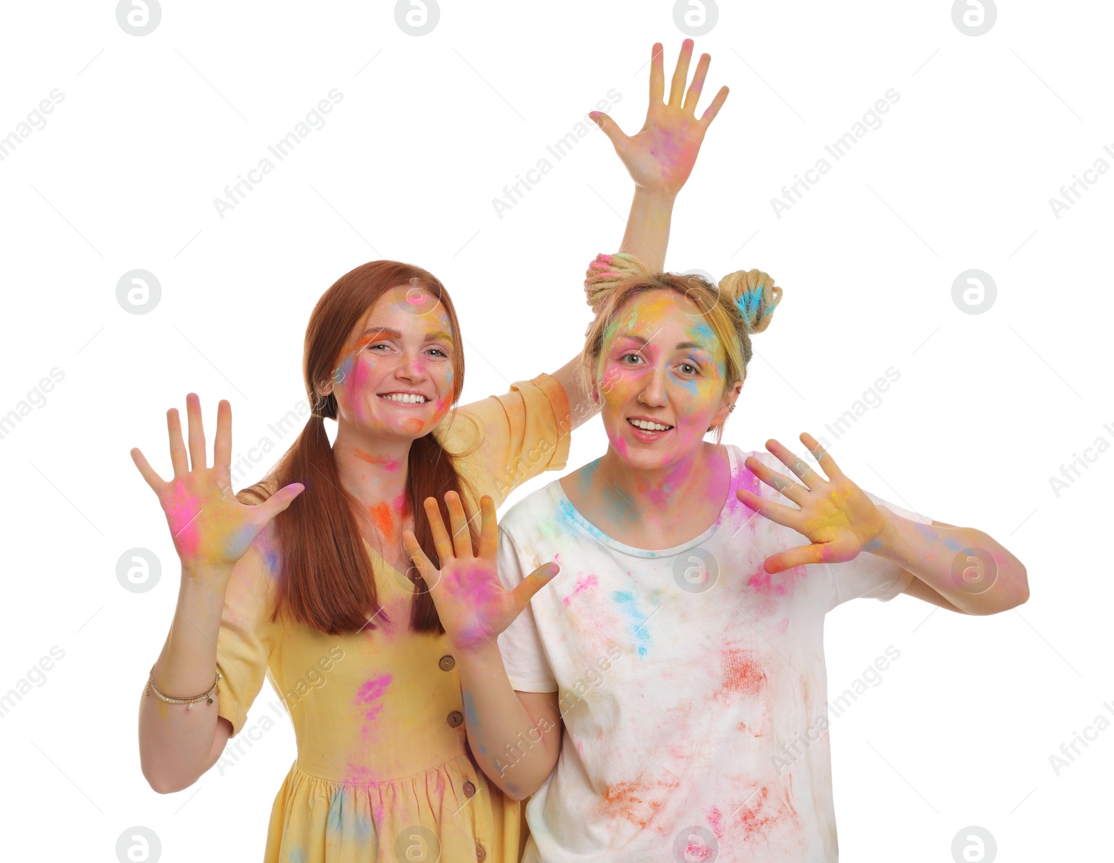 Women covered with colorful powder dyes on white background. Holi festival celebration Photo of Women covered with colorful powder dyes on white background. Holi festival celebration