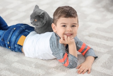 Cute little child with cat at home Photo of Cute little child with cat at home