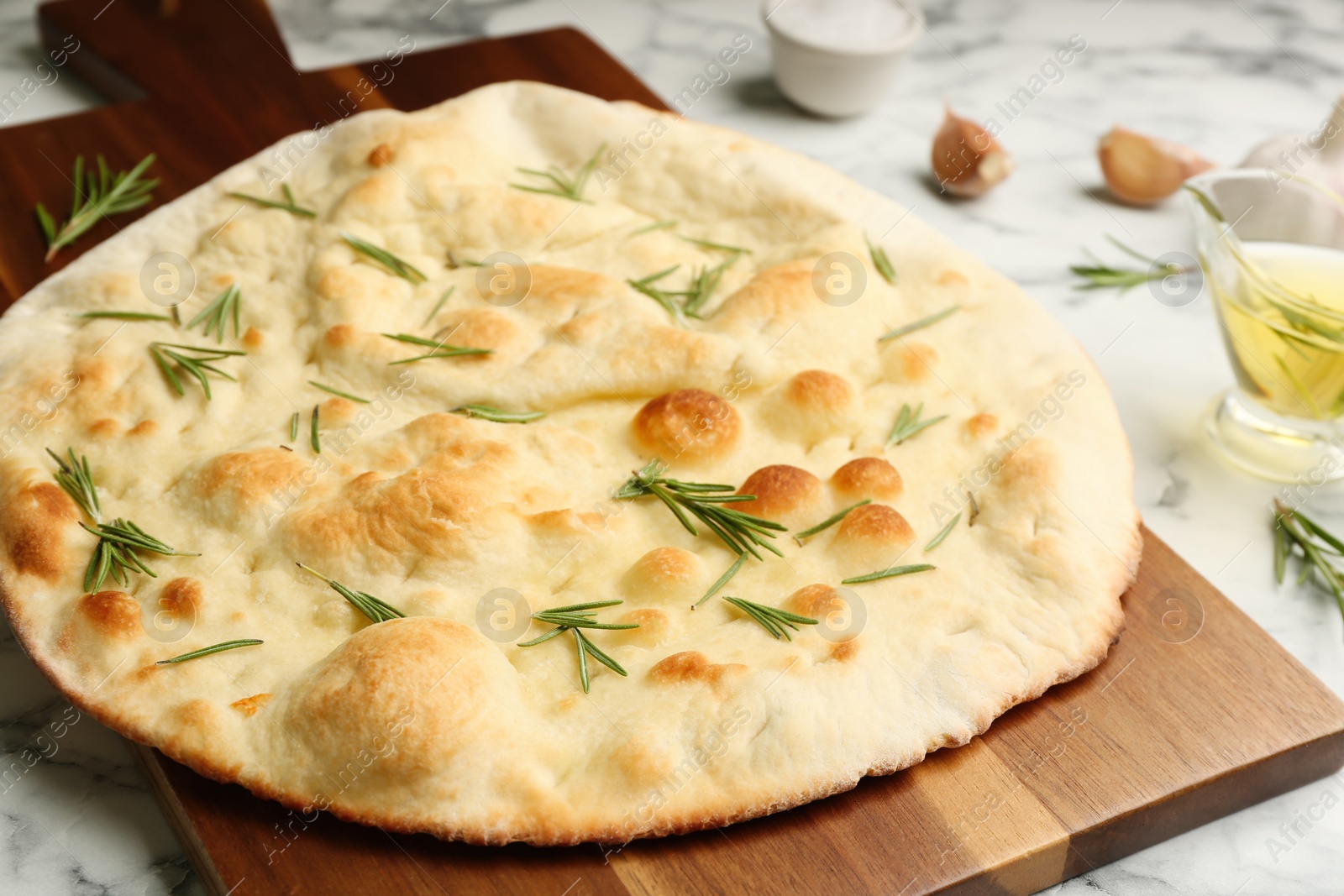 Delicious focaccia bread on wooden board, closeup Photo of Delicious focaccia bread on wooden board, closeup