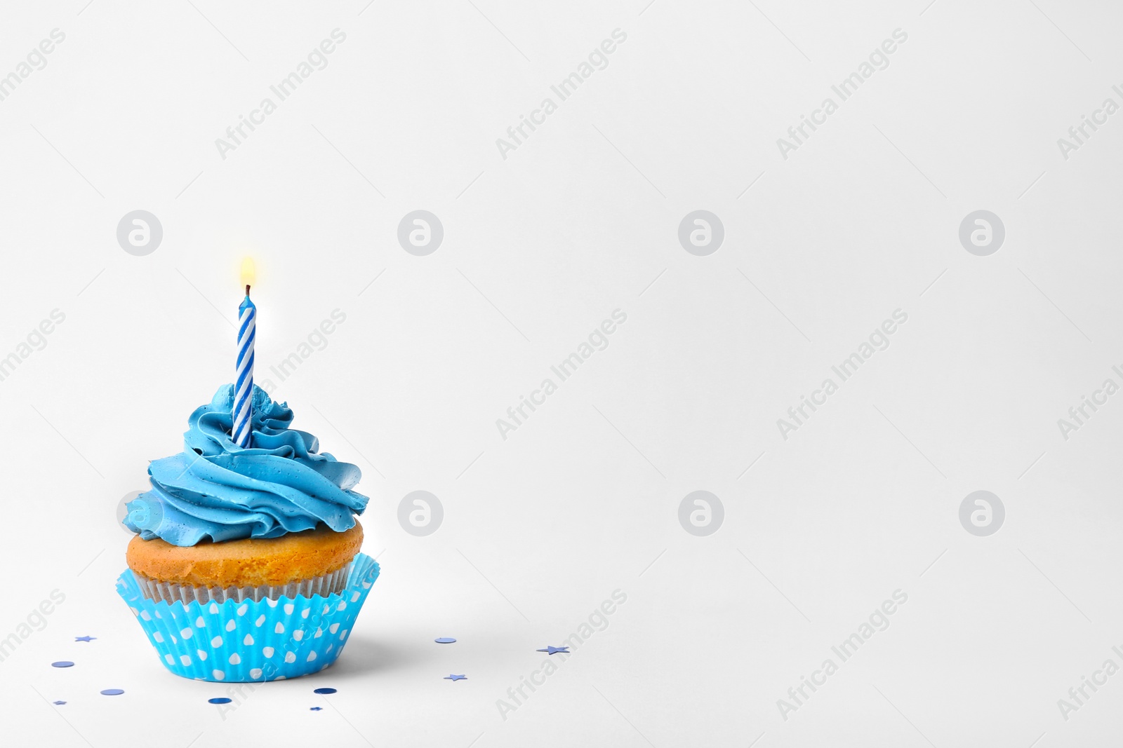 Birthday cupcake with candle on white background Photo of Birthday cupcake with candle on white background