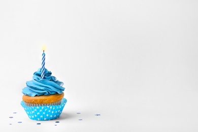Birthday cupcake with candle on white background Photo of Birthday cupcake with candle on white background