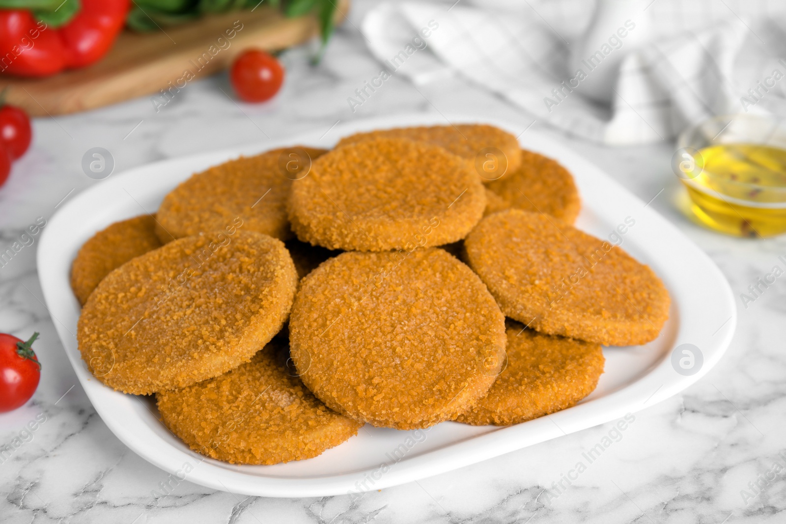Delicious fried breaded cutlets on white marble table Photo of Delicious fried breaded cutlets on white marble table