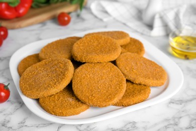 Delicious fried breaded cutlets on white marble table Photo of Delicious fried breaded cutlets on white marble table