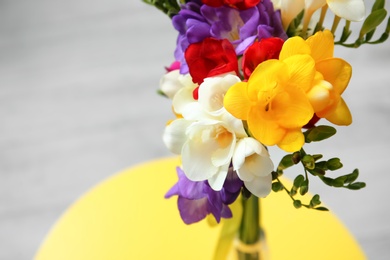Beautiful freesia bouquet on table Photo of Beautiful freesia bouquet on table