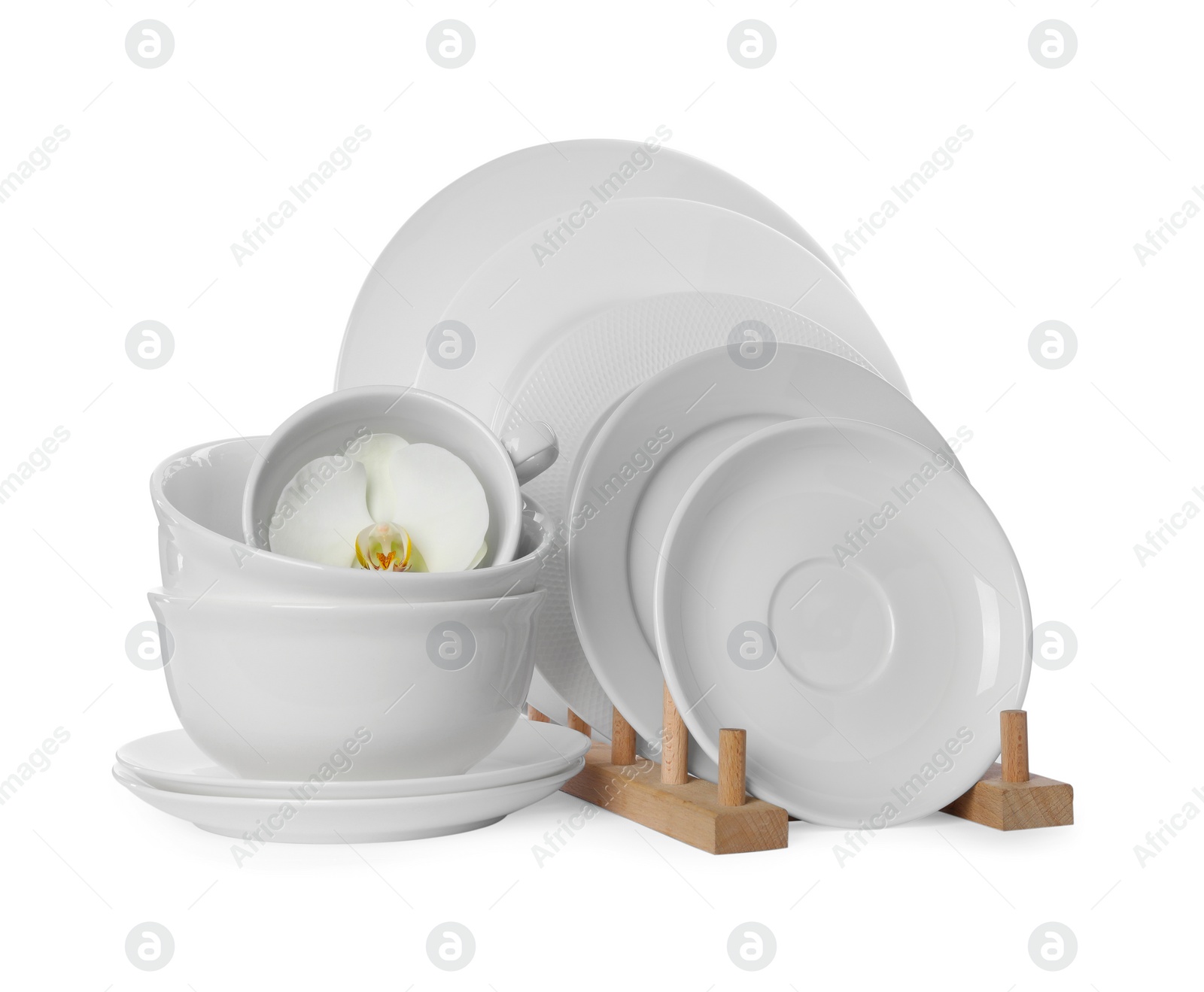 Set of dishware and flower on white background Photo of Set of dishware and flower on white background