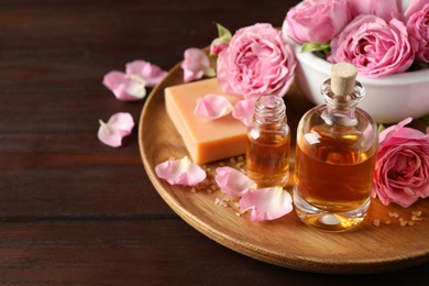 Composition with aroma oil on wooden table, space for text Photo of Composition with aroma oil on wooden table, space for text