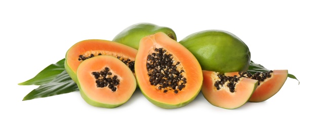 Fresh ripe papaya fruits with green leaves on white background Photo of Fresh ripe papaya fruits with green leaves on white background
