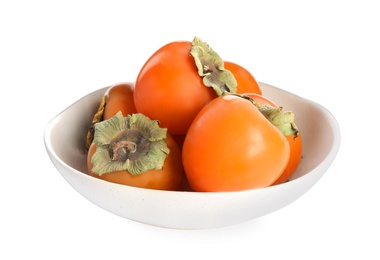 Bowl with delicious persimmons isolated on white Photo of Bowl with delicious persimmons isolated on white