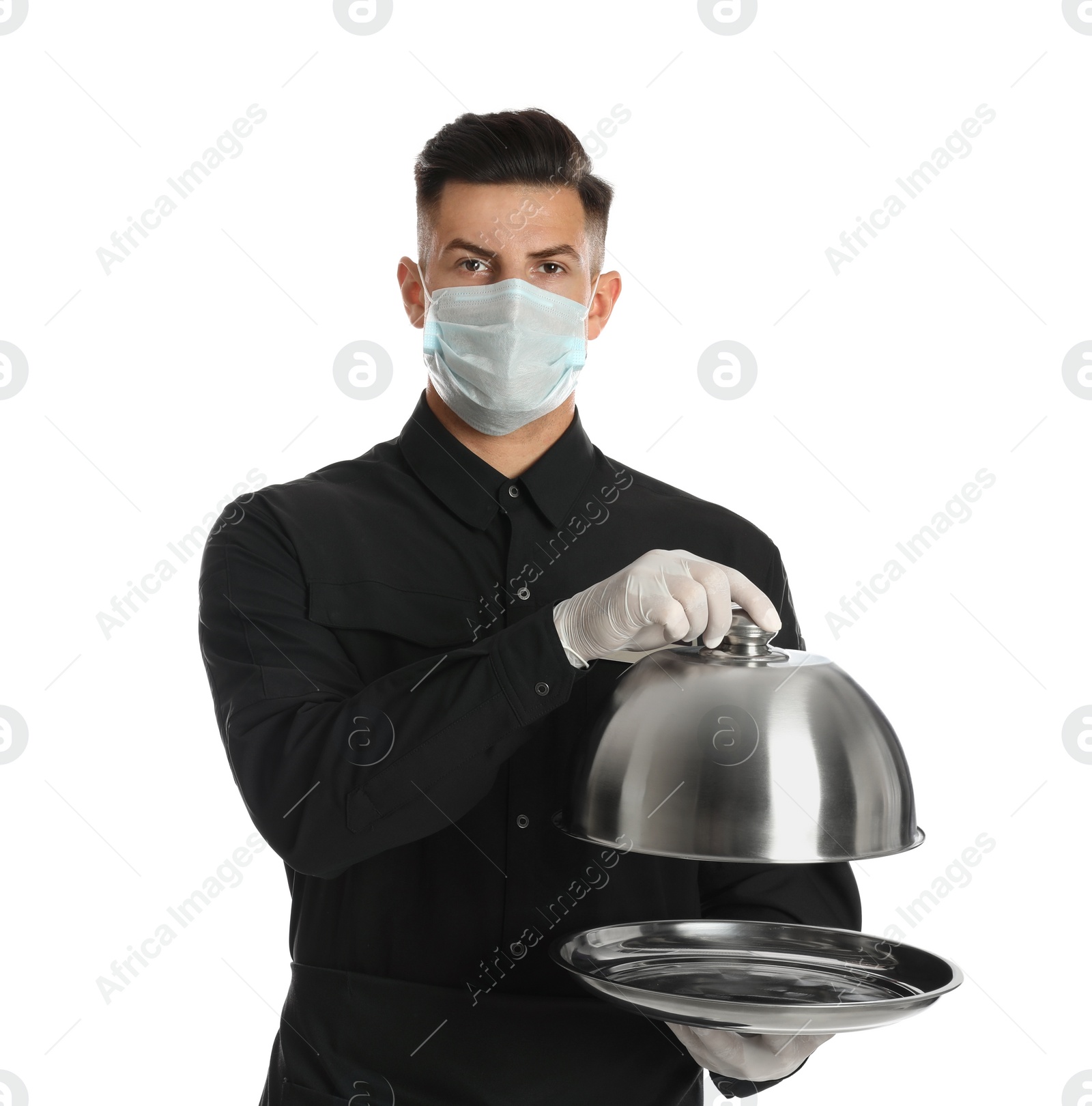 Waiter in medical face mask holding tray with lid on white background Photo of Waiter in medical face mask holding tray with lid on white background