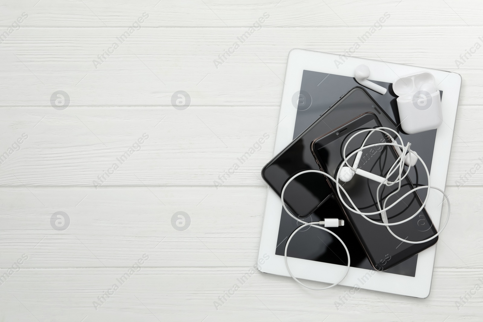 Different gadgets on white wooden table, flat lay with space for text. Digital detox concept Photo of Different gadgets on white wooden table, flat lay with space for text. Digital detox concept