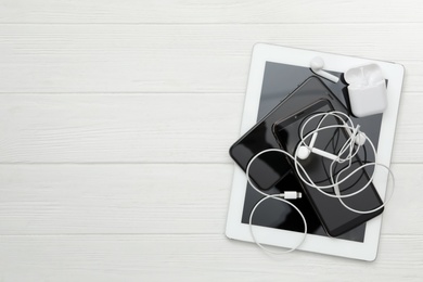 Different gadgets on white wooden table, flat lay with space for text. Digital detox concept Photo of Different gadgets on white wooden table, flat lay with space for text. Digital detox concept