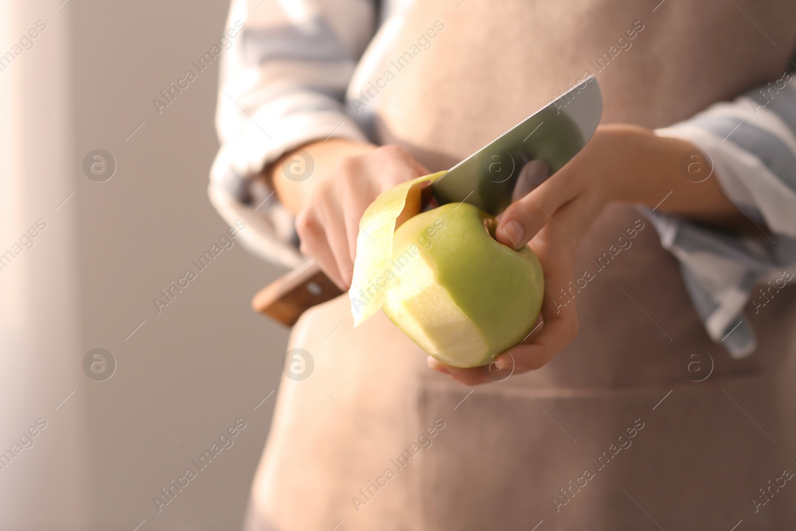 Woman peeling ripe apple, closeup Photo of Woman peeling ripe apple, closeup