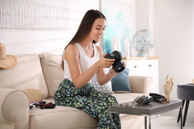 Young photographer taking picture of jewelry indoors Photo of Young photographer taking picture of jewelry indoors