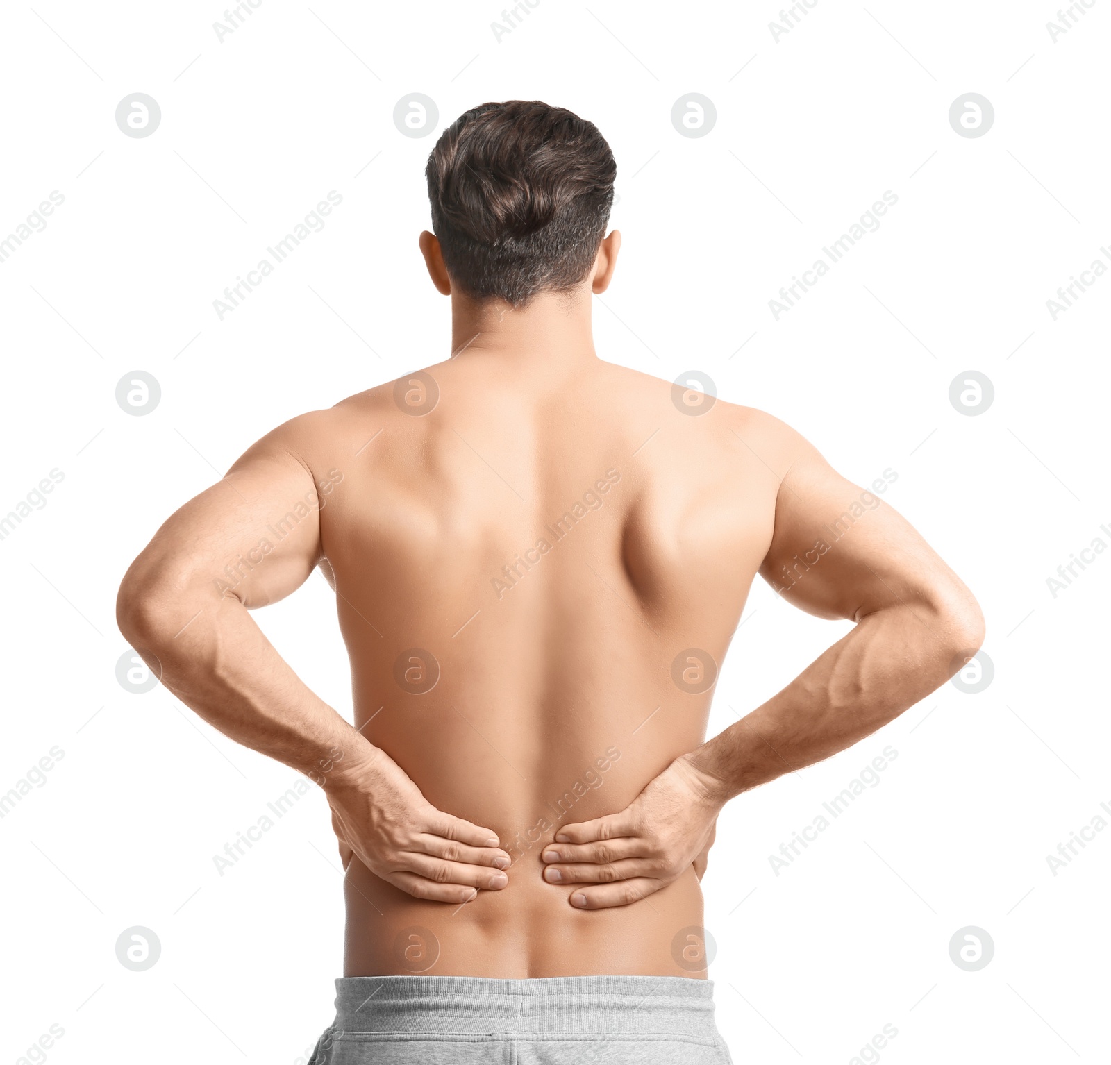 Young man suffering from back pain on white background Photo of Young man suffering from back pain on white background