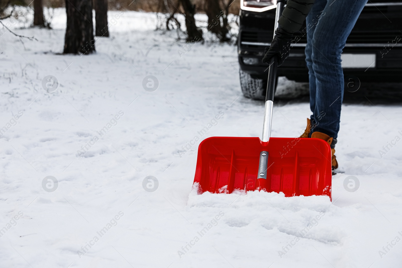 Man removing snow with shovel near car outdoors on winter day, closeup Photo of Man removing snow with shovel near car outdoors on winter day, closeup
