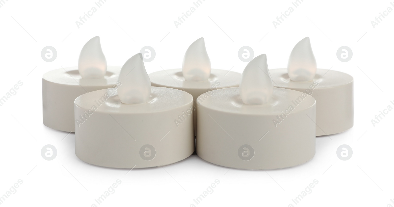 Decorative flameless LED candles on white background Photo of Decorative flameless LED candles on white background