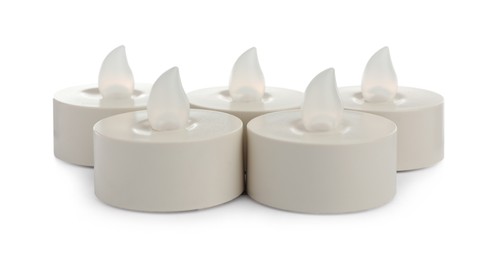 Decorative flameless LED candles on white background Photo of Decorative flameless LED candles on white background