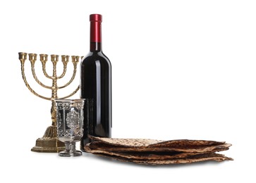 Tasty matzos, wine and menorah on white background. Passover (Pesach) celebration Photo of Tasty matzos, wine and menorah on white background. Passover (Pesach) celebration