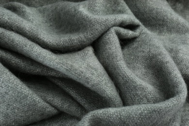 Stylish grey cashmere scarf as background, closeup Photo of Stylish grey cashmere scarf as background, closeup