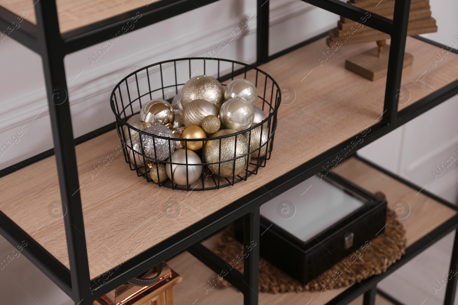 Stylish shelving unit with Christmas balls indoors. Interior design Photo of Stylish shelving unit with Christmas balls indoors. Interior design