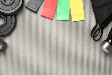 Flat lay composition with fitness elastic bands on grey background. Space for text Photo of Flat lay composition with fitness elastic bands on grey background. Space for text