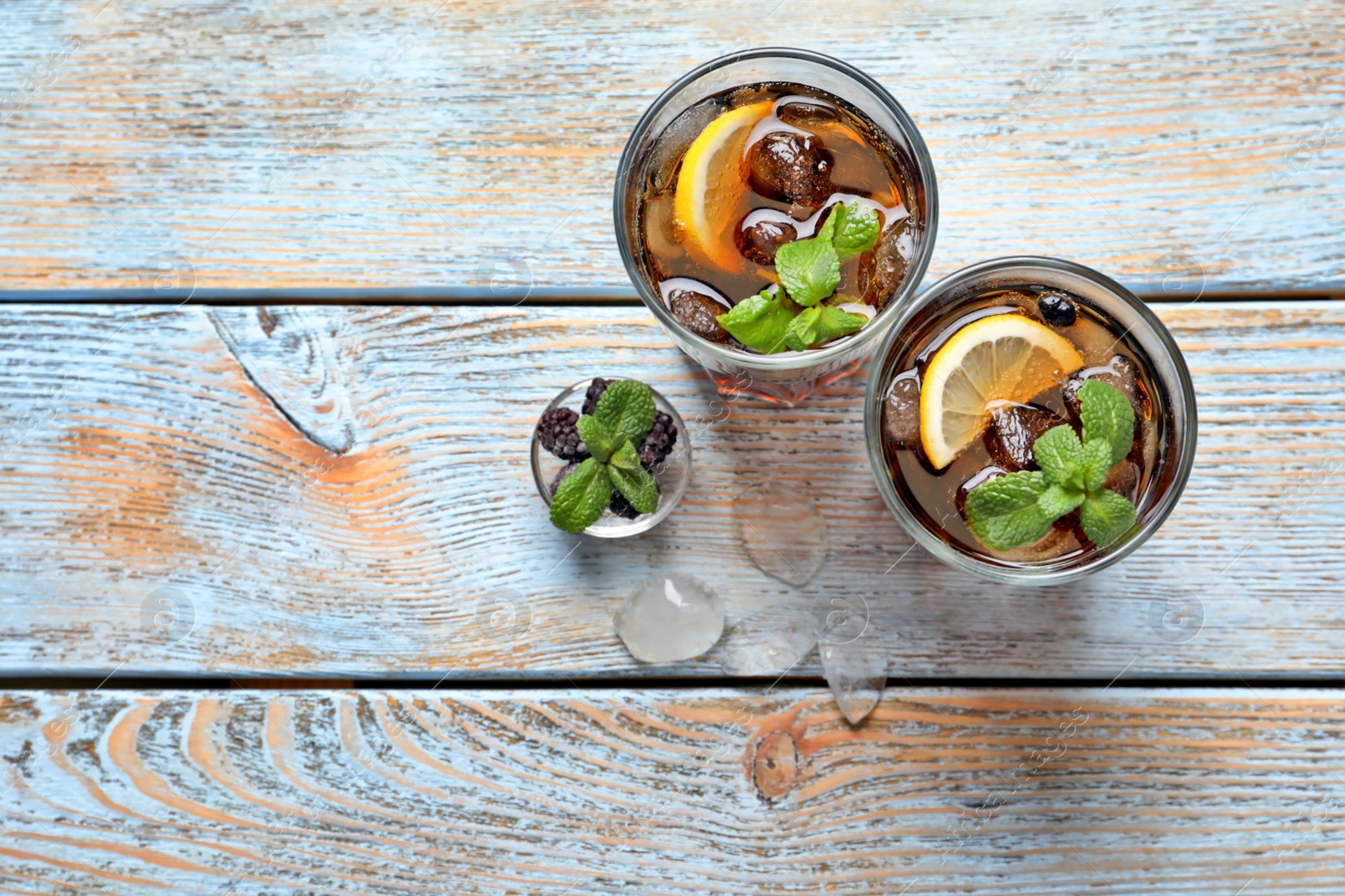 Glasses of fresh lemonade on wooden table Photo of Glasses of fresh lemonade on wooden table