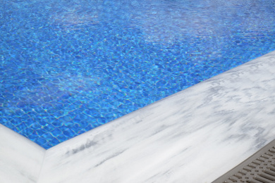 Photo of Outdoor swimming pool with clear water on sunny day