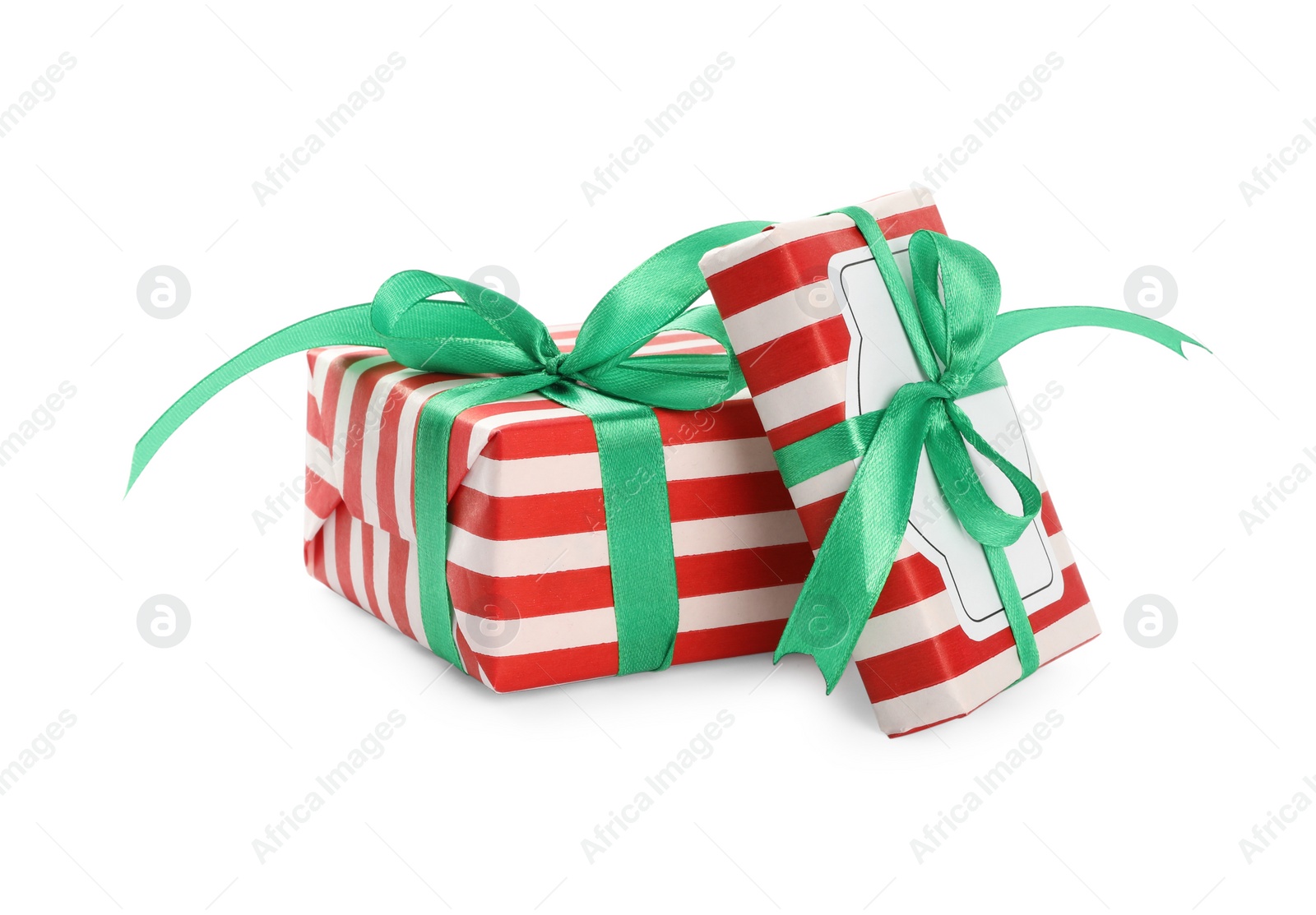 Christmas gift boxes decorated with green bows on white background Photo of Christmas gift boxes decorated with green bows on white background