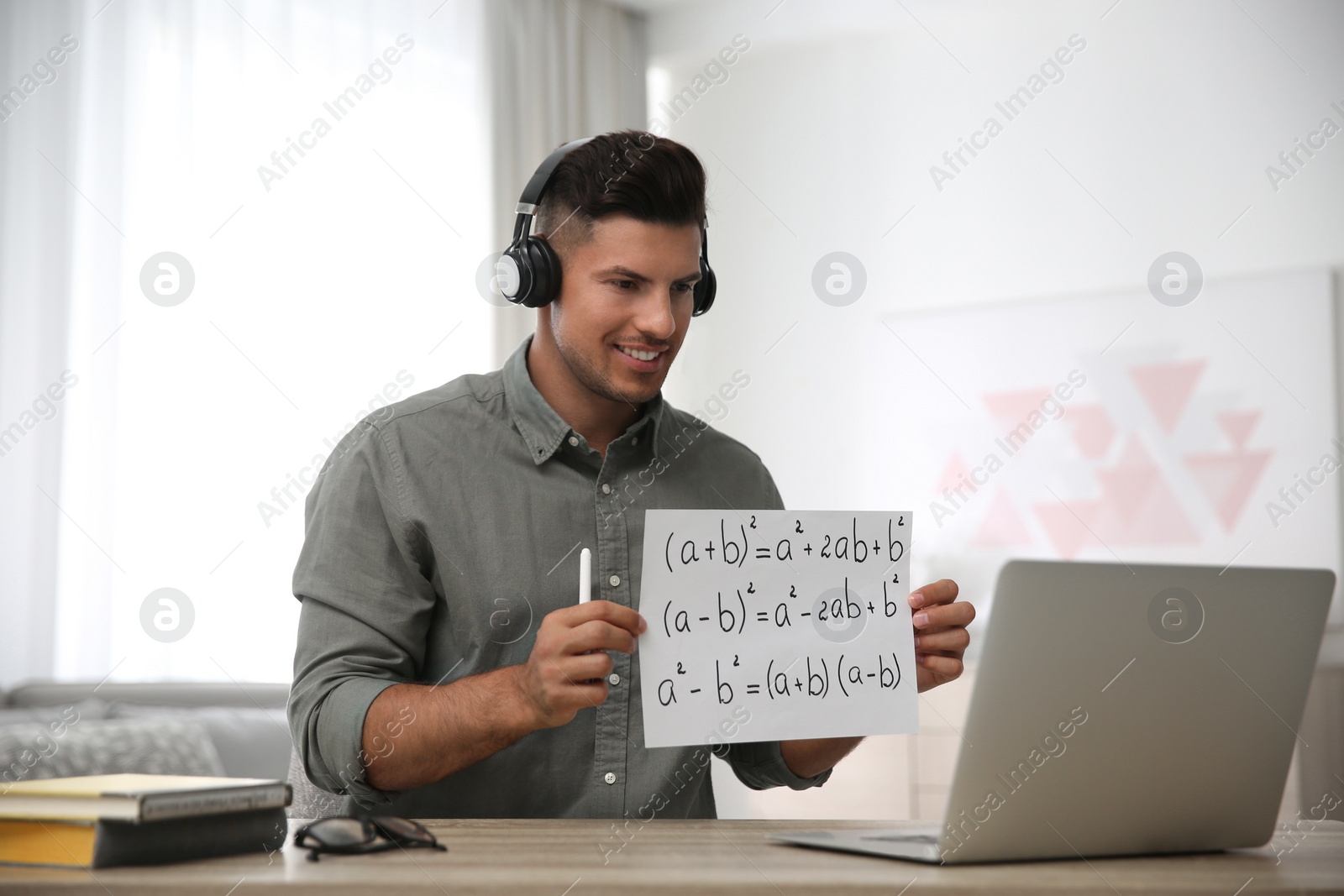 Teacher giving online lesson during quarantine. Studying at home Photo of Teacher giving online lesson during quarantine. Studying at home