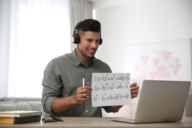 Teacher giving online lesson during quarantine. Studying at home Photo of Teacher giving online lesson during quarantine. Studying at home