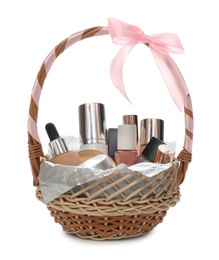 Cosmetic gift set in wicker basket isolated on white Photo of Cosmetic gift set in wicker basket isolated on white