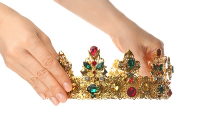 Photo of Woman holding beautiful golden crown on white background, closeup. Fantasy item