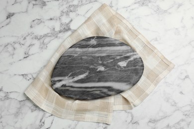 Kitchen towel and stone board on white marble table, top view Photo of Kitchen towel and stone board on white marble table, top view