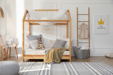 Stylish child room interior with house bed Photo of Stylish child room interior with house bed