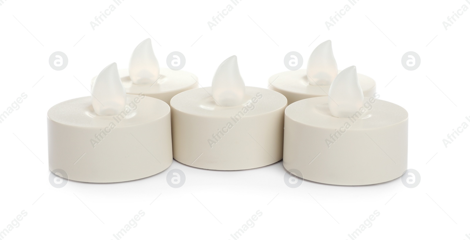 Decorative flameless LED candles on white background Photo of Decorative flameless LED candles on white background
