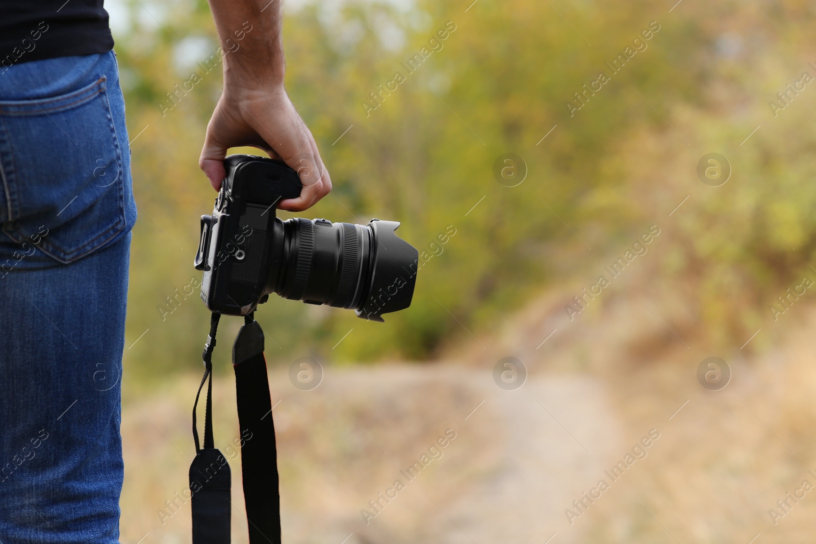 Photographer with professional camera in countryside closeup Photo of Photographer with professional camera in countryside closeup