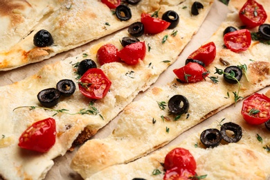 Delicious focaccia bread with olives and tomatoes, closeup Photo of Delicious focaccia bread with olives and tomatoes, closeup