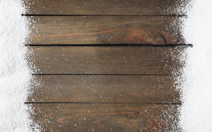 Artificial snow on wooden background, flat lay with space for text. Christmas decor Photo of Artificial snow on wooden background, flat lay with space for text. Christmas decor