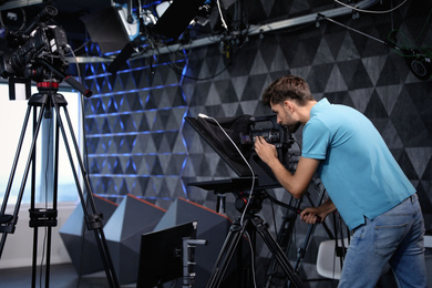 Photo of Professional video camera operator working in studio