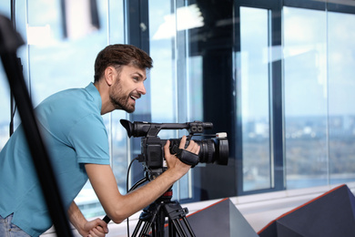 Professional video camera operator working in studio Photo of Professional video camera operator working in studio