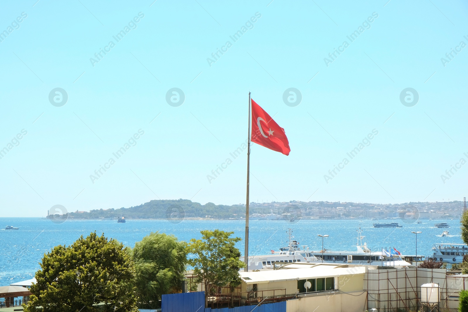 ISTANBUL, TURKEY - JULY 29, 2019: Turkish flag in hotel at Bosphorus Photo of ISTANBUL, TURKEY - JULY 29, 2019: Turkish flag in hotel at Bosphorus