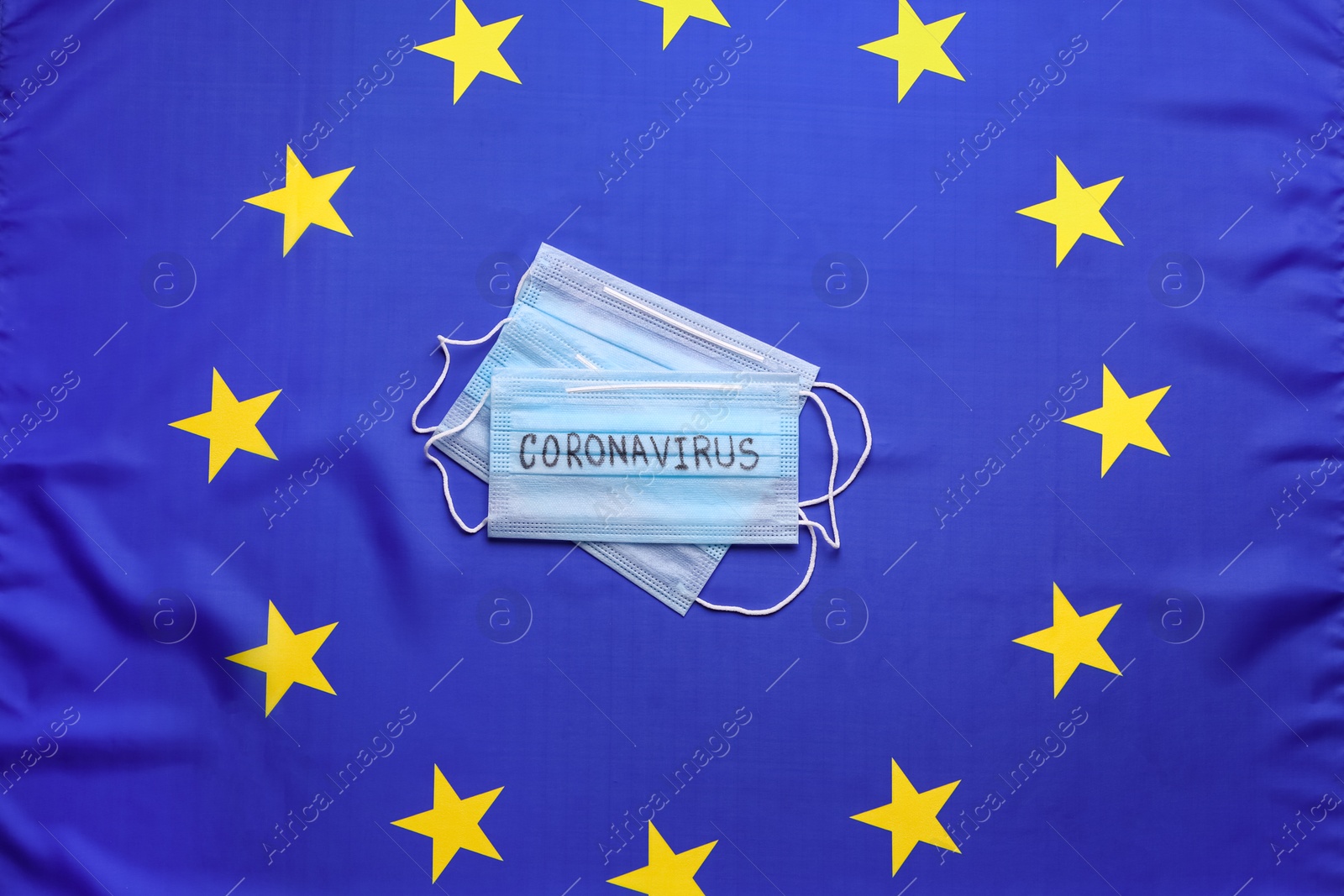 Protective masks on European Union flag background, top view. Coronavirus outbreak Photo of Protective masks on European Union flag background, top view. Coronavirus outbreak