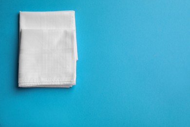 Stylish white handkerchiefs on light blue background, flat lay. Space for text Photo of Stylish white handkerchiefs on light blue background, flat lay. Space for text