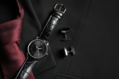 Flat lay composition with luxury wrist watch on black jacket Photo of Flat lay composition with luxury wrist watch on black jacket