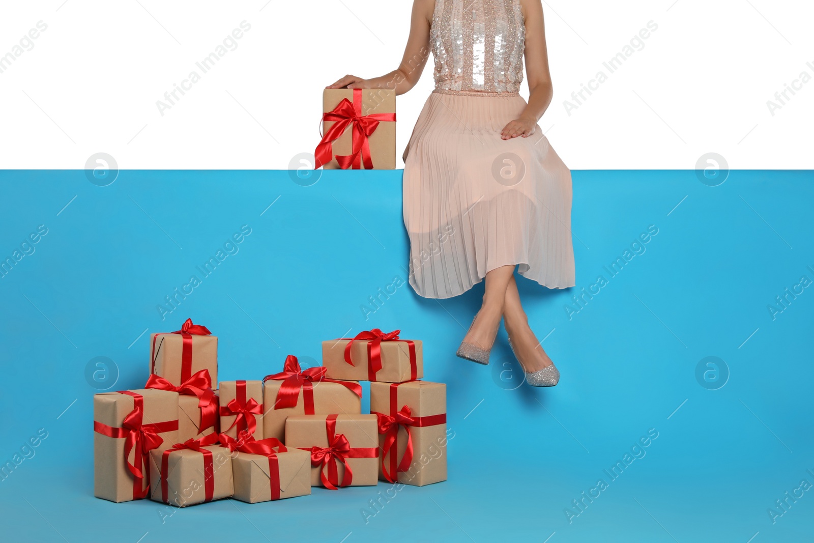 Woman and gift boxes on light blue background, closeup. Black Friday Photo of Woman and gift boxes on light blue background, closeup. Black Friday
