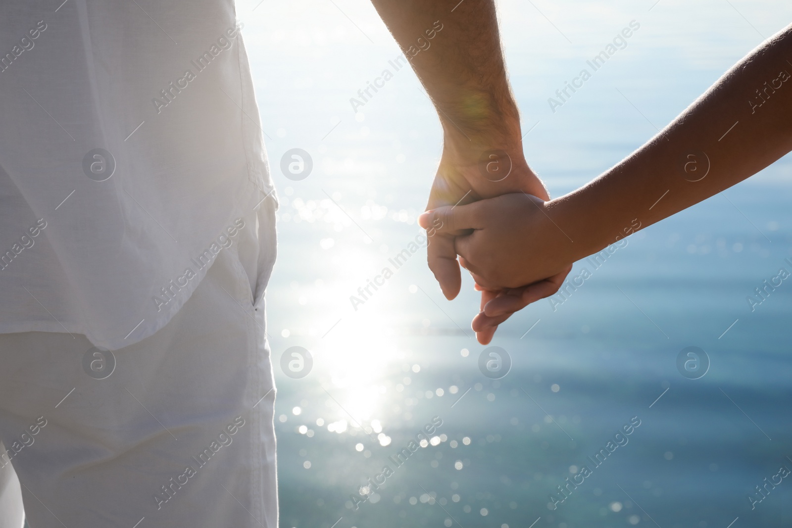 Couple holding hands together near river, closeup. Nature healing power Photo of Couple holding hands together near river, closeup. Nature healing power