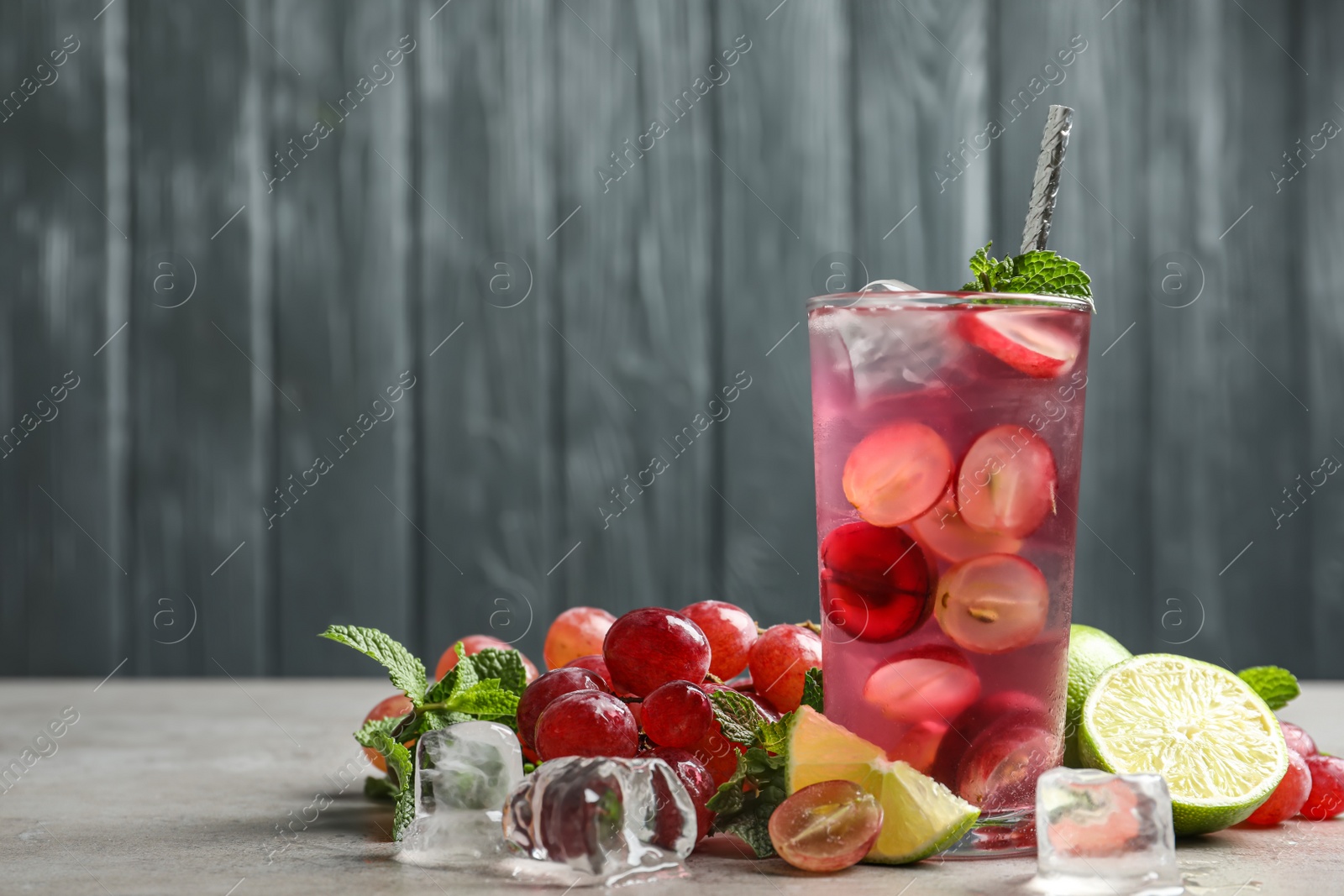 Soda water with grapes, ice and mint on table, space for text. Refreshing drink Photo of Soda water with grapes, ice and mint on table, space for text. Refreshing drink