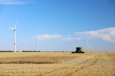 Modern combine harvester working in agricultural field Photo of Modern combine harvester working in agricultural field